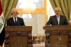 Iranian Foreign Minister Mohammad Javad Zarif (R) and his Iraqi counterpart Ibrahim al-Jaafari hold a press conference in Tehran on December 7, 2014, ahead of a conference with their Syrian counterpart on combating extremism. AFP PHOTO/ATTA KENARE