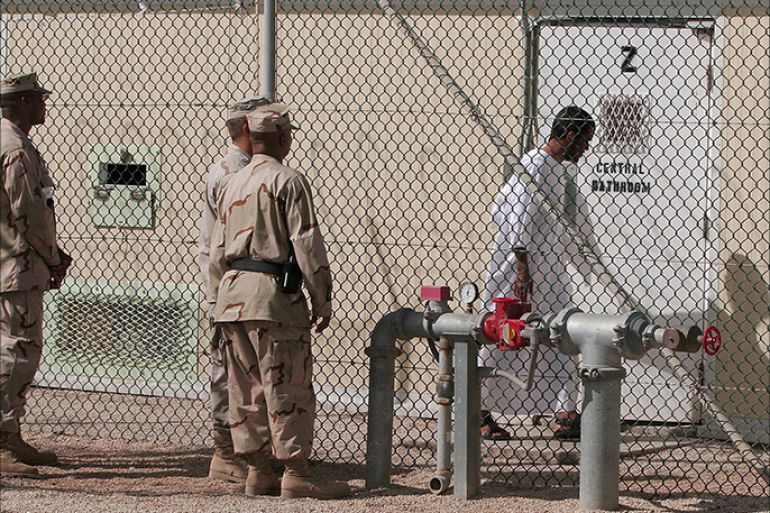 epa00643121 A group of US soldiers observe a full complaisance detainee at Camp Delta in Guantanamo Naval Base, Wednesday, 15 February 2006, as he gets in his cell block. According to a UN human rights report released today, 16 February 2006, the United States must shut down its detention centre at Guantanamo Bay without delay and urged Washington to try to release the more than 500 detainees still held there. The 54-page document charged that US treatment of "war on terror" detainees at the naval base on Cuba violated their rights to physical and mental health and in some cases amounted to torture. EPA/JOHN RILEY