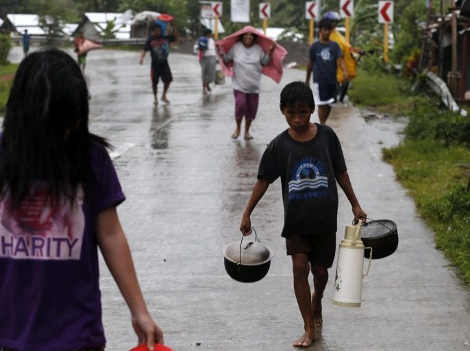 Filipino residents evacuate to safer ground in the town of Pinalangga, Samar island, Philippines, 06 December 2014. More people fled their homes in the Philippines as the strongest typhoon to hit the country since last year slowed down, officials said. Typhoon Hagupit was packing maximum winds of 195 kilometres per hour (kph) and gusts of 230 kph, the weather bureau said. It was expected to hit the eastern Philippines early Sunday morning after its advance slowed to 10 kph, which would bring more rains over the affected areas, it added.