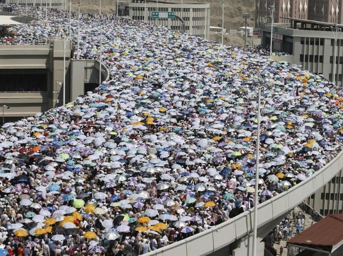 Muslim pilgrims walk on a bridge as they head to cast stones at pillars symbolizing Satan during the final day of the annual haj pilgrimage in Mina on the third day of Eid al-Adha, near the holy city of Mecca, October 6, 2014. Muslims around the world celebrate Eid al-Adha to mark the end of the haj pilgrimage by slaughtering sheep, goats, camels and cows to commemorate Prophet Abraham's willingness to sacrifice his son, Ismail, on God's command. REUTERS/Muhammad Hamed (SAUDI ARABIA - Tags: RELIGION)