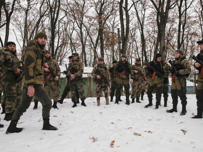 Pro-Russian separatists from the Chechen "Death" battalion take part in a training exercise in the territory controlled by the self-proclaimed Donetsk People's Republic, eastern Ukraine, December 8, 2014. Chanting "Allahu Akbar" (God is greatest), dozens of armed men in camouflage uniforms from Russia's republic of Chechnya train in snow in a camp in the rebel-held east Ukraine. They say their "Death" unit fighting Ukrainian forces has 300 people, mostly former state security troops in the mainly-Muslim region where Moscow waged two wars against Islamic insurgents and which is now run by a Kremlin-backed strongman. Picture taken December 8, 2014. REUTERS/Maxim Shemetov (UKRAINE - Tags: POLITICS CIVIL UNREST CONFLICT)
