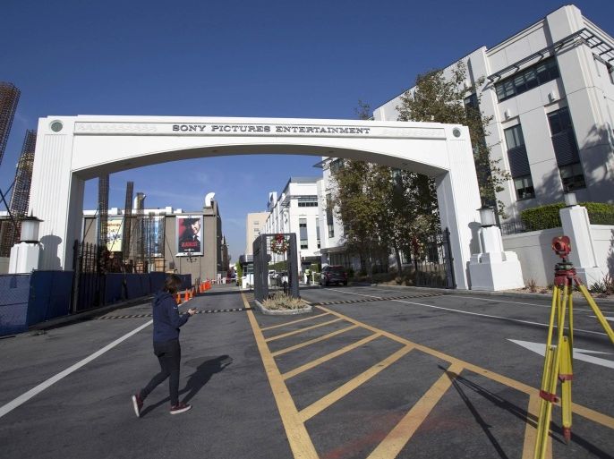 A person walks by an entrance gate to Sony Pictures Studios is pictured in Culver City, California December 19, 2014. Washington made the woes of cyberattack victim Sony Pictures its own on Thursday as the White House acknowledged that the devastating strike against the big Hollywood studio was a matter of national security that would be met by a forceful government response. REUTERS/Mario Anzuoni (UNITED STATES - Tags: ENTERTAINMENT SOCIETY)