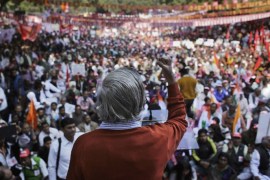 A leader addresses a trade union workers' rally against the alleged anti-worker and pro-corporate policies of the government near the Indian parliament in New Delhi, India, Friday, Dec. 5, 2014. The protest is a part of the All India Protest Day against the amendments in labor laws, organized by Central Trade Unions, independent employees federations and associations of Banks, Insurance, Defense, Telecommunications and other sectors. (AP Photo/Altaf Qadri)