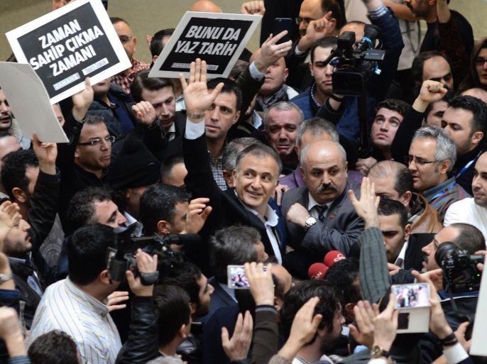 A handout picture provided by Zaman newspaper showing supporters of Fethullah Gulen Movement surround Ekrem Dumanli (C), chief editor of Zaman newspapers, after Turkish plain-clothed police officers detain him as a part of a Turkish police operation targeting the media close to the Fethullah Gülen, in Istanbul, Turkey 14 December 2014. Early 14 December police simultaneously arrested broadcasters from a television station and a former anti-terrorism chief and journalists according to local media. EPA/ISA SIMSEK / ZAMAN HANDOUT