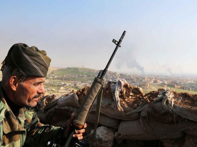 MOSUL, IRAQ - DECEMBER 22: Sniper of Peshmerga forces is positioned on Muawiyah hill recaptured following attacks against Islamic State of Iraq and Levant (ISIL) fighters in Sinjar district of Mosul, Iraq on December 22, 2014. Peshmerga forces stage attacks against ISIL to liberate ISIL occupied Sinjar.