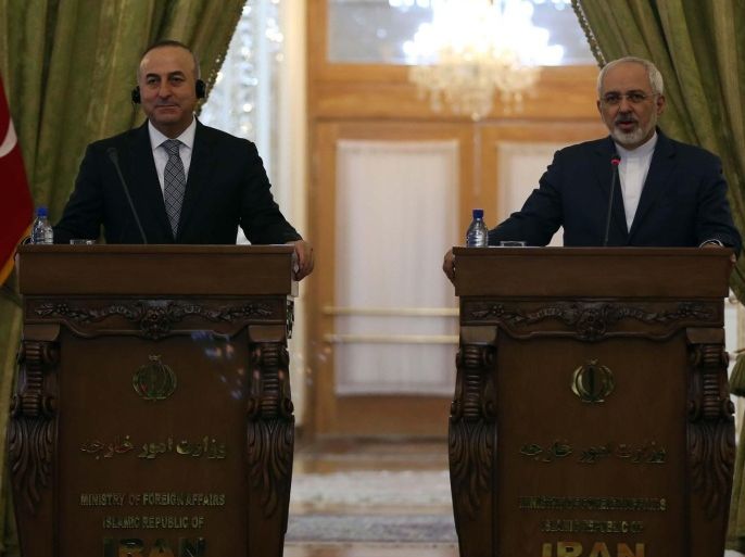 TEHRAN, IRAN - DECEMBER 17: Turkish Foreign Minister Mevlut Cavusoglu (L) and his Iranian counterpart Mohammad Javad Zarif (R) hold a joint press conference at Ministry of Foreign Affairs building in Tehran, Iran on December 17, 2014.