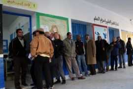 BEN AROUS, TUNISIA - DECEMBER 21: Tunisians wait in line to cast their ballots to elect the country's next president in a runoff vote at Nehic Elkrivan school in Ben Arous, Tunisia on December 21, 2014. Nearly 5.3 million Tunisian voters are eligible to cast ballot in Sunday's election, which is billed as the final round of the country's first democratic presidential vote.