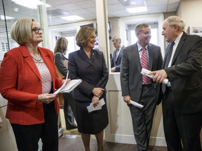 From left, Senate Armed Services Committee members Sen. Claire McCaskill, D-Mo., Sen. Deb Fischer, R-Neb., Sen. Lindsey Graham, R-S.C., and Chairman Sen. Carl Levin, D-Mich., confer before holding a news conference about the release of a Pentagon report on sexual assault in the military, Thursday, Dec. 4, 2014, on Capitol Hill in Washington. Defense Secretary Chuck Hagel said Thursday that there has been “real progress” in the Pentagon’s effort to combat sexual assault among the military, but he is troubled that more than 60 percent of the women who filed reports said they faced retaliation. (AP Photo/J. Scott Applewhite)