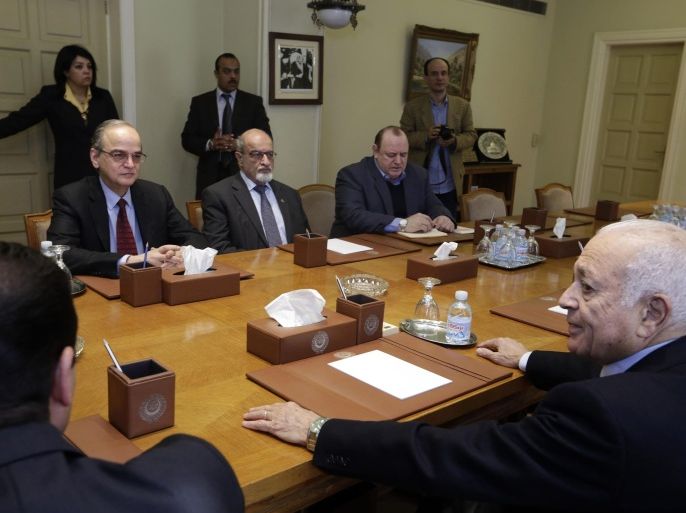 The Arab League's Secretary-General Nabil Elaraby, right, meets with Hadi Bahra, the head of the Syrian National Coalition, the country's main political opposition group, left, and Haitham al-Maleh, a member of the group, second left, at the league's headquarters in Cairo, Egypt, Saturday, Dec. 27, 2014. (AP Photo/Amr Nabil)
