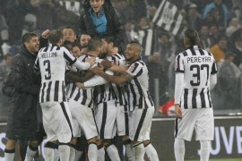 Juventus' players celebrate at the end of a Serie A soccer match against Torino at the Juventus stadium in Turin, Italy, Sunday, Nov. 30, 2014. Juventus midfielder Andrea Pirlo scored deep into stoppage time as 10-man Juventus snatched a 2-1 win over Torino in a derby match on Sunday to move provisionally six points clear in Serie A. (AP Photo/Massimo Pinca)