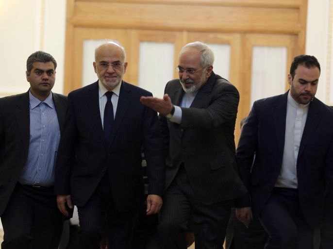 Iranian Foreign Minister Mohammad Javad Zarif (C-R) and his Iraqi counterpart Ibrahim al-Jaafari (C-L) arrive for a meeting in Tehran on December 7, 2014, ahead of a conference with their Syrian counterpart on combating extremism. AFP PHOTO/ATTA KENARE