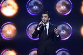 Syrian singer Hazem Sharif, 21, from Aleppo in northern Syria, performs during the the last prime of Arab Idol Show broadcast by MBC Arabic satellite channel in Zouk Mosbeh neighborhood, north of Beirut, Lebanon, Saturday, Dec. 13, 2014. Sharif was crowned the most watched show in the Middle East, beating off his two rivals Palestinian Haitham Khalaily and Majed Al-Madani from Saudi Arabia. (AP Photo/Bilal Hussein)