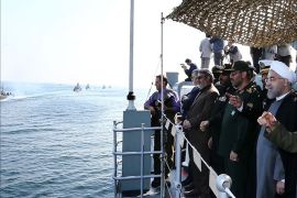 epa04543387 A handout picture made available by the presidential official website shows Iranian President Hassan Rowhani (R) attending the navy parade during a military drill in the Oman Sea, port city Bandar Jask southern Iran, 31 December 2014. Iran's national army has held a military drill near the Strait of Hormuz at the entrance to the Persian Gulf. EPA/PRESIDENTIAL OFFICIAL WEBSITE/HANDOUT HANDOUT EDITORIAL USE ONLY/NO SALES
