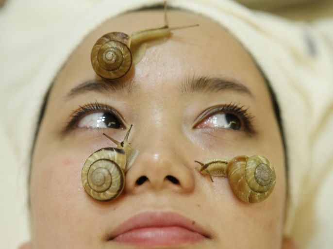 Snails crawl on the face of a woman during a demonstration of a new beauty treatment at Clinical-Salon Ci:z.Labo in central Tokyo July 17, 2013. Clinical-Salon Ci:z.Labo, which began the unique facial earlier this week, offers the 10,500 yen ($110) five-minute session with the snails as an optional add-on for customers who apply for a "Celeb Escargot Course", an hour-long treatment routine of massages and facials based on products made from snail slime that costs 24,150 yen. According to a beautician at the salon, the snail slime is believed to make one's skin supple as well as remove dry and scaly patches. Picture taken July 17, 2013.