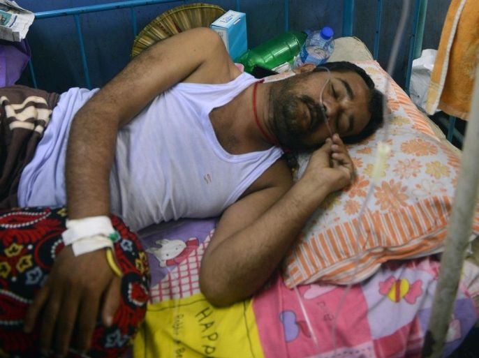 An Indian patient lies in a ward while being treated for Japanese encephalitis at the North Bengal Medical College Hospital (NBMCH) on the outskirts of Siliguri on July 24, 2014. Recent outbreaks of encephalitis in India have killed more than 150 people, with health officials on alert fearing the death toll could rise further, state government directors said. AFP PHOTO/ Diptendu DUTTA