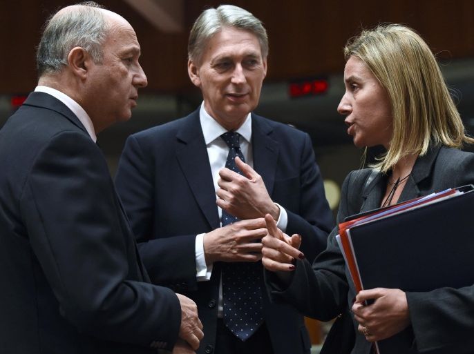 (LtoR) French Foreign Affairs minister Laurent Fabius (L) talks with British Foreign Secretary Philip Hammond (C), High and Representative of the Union for Foreign Affairs and Security Policy / Vice-President of the Commission Federica Mogherini during a EU Foreign Affairs Council meeting at EU headquarters in Brussels on January 19, 2015. EU foreign ministers are to discuss ways to boost anti-terror cooperation in the wake of the Paris attacks and the dismantling of a jihadist cell in Belgium. AFP PHOTO/JOHN THYS