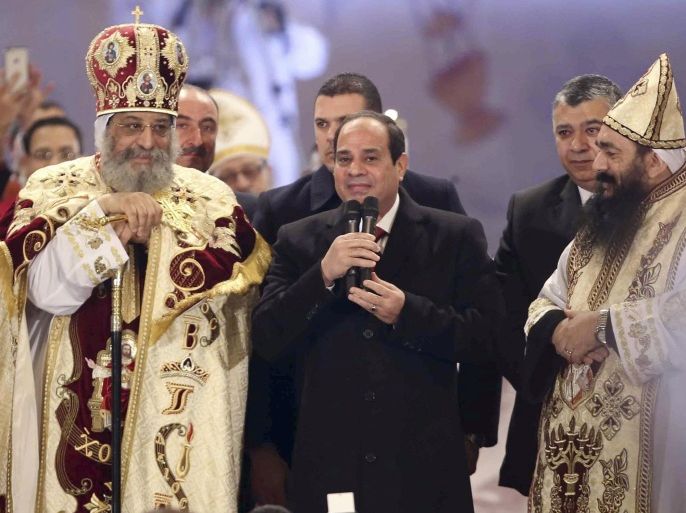 Egyptian President Abdel Fattah al-Sisi (2nd R) talks next to Coptic Pope Tawadros II as he attends Christmas Eve Mass at St. Mark's Cathedral, the seat of the Coptic Orthodox Pope in Cairo, January 6, 2015. REUTERS/Al Youm Al Saabi Newspaper (EGYPT - Tags: RELIGION POLITICS) EGYPT OUT. NO COMMERCIAL OR EDITORIAL SALES IN EGYPT
