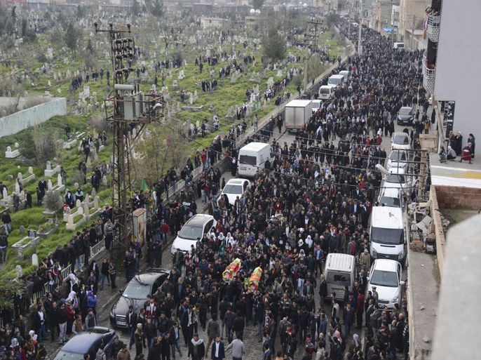 Kurdish people carry the coffins