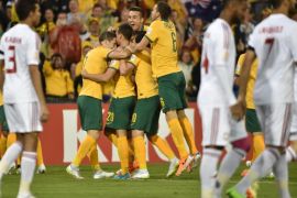Australian players (C) celebrate scoring the first goal against United Arab Emirates in their AFC Asian Cup semi-final football match in Newcastle on January 27, 2015. AFP PHOTO/Peter PARKS --IMAGE RESTRICTED TO EDITORIAL USE - STRICTLY NO COMMERCIAL USE