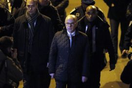 French interior Minister Bernard Cazeneuve arrives outside the French satirical newspaper Charlie Hebdo's office, in Paris, Wednesday, Jan. 7, 2015. Masked gunmen shouting "Allahu akbar!" stormed the Paris offices of the satirical newspaper Charlie Hebdo, killing at least 12 people, including the paper's editor and a cartoonist, before escaping in a getaway car. It was France's deadliest terror attack in at least two decades. (AP Photo/Francois Mori)