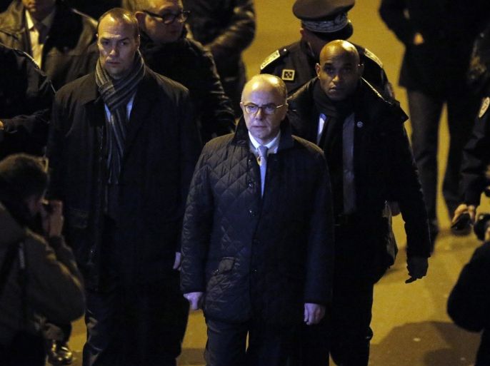 French interior Minister Bernard Cazeneuve arrives outside the French satirical newspaper Charlie Hebdo's office, in Paris, Wednesday, Jan. 7, 2015. Masked gunmen shouting "Allahu akbar!" stormed the Paris offices of the satirical newspaper Charlie Hebdo, killing at least 12 people, including the paper's editor and a cartoonist, before escaping in a getaway car. It was France's deadliest terror attack in at least two decades. (AP Photo/Francois Mori)