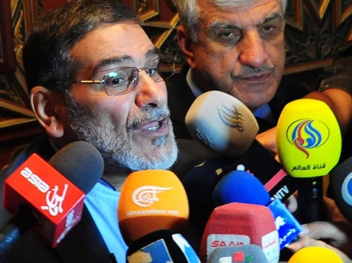 Iranian secretary of the Supreme National Security Council, Ali Shamkhani (L) speaks to reporters at the Damascus airport on September 30, 2014. AFP PHOTO/ STR