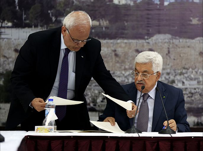 epa04543728 Palestinian President Mahmoud Abbas signs more than 20 international treaties, including the Rome Statute of the International Criminal Court, during a special leadership meeting in the West Bank city of Ramallah, 31 December 2014. The move came after the UN Security Council's rejection of a Palestinian-drafted resolution calling for an end to the Israeli occupation of Palestinian territories within three years. EPA/ALAA BADARNEH