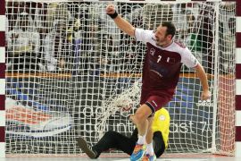 Qatar's Bertrand Roine celebrates after scoring a goal during the 24th Men's Handball World Championships semi-finals match between Qatar and Poland at the Lusail Multipurpose Hall in Doha on January 30, 2015. AFP PHOTO / AL-WATAN DOHA / KARIM JAAFAR==QATAR OUT==