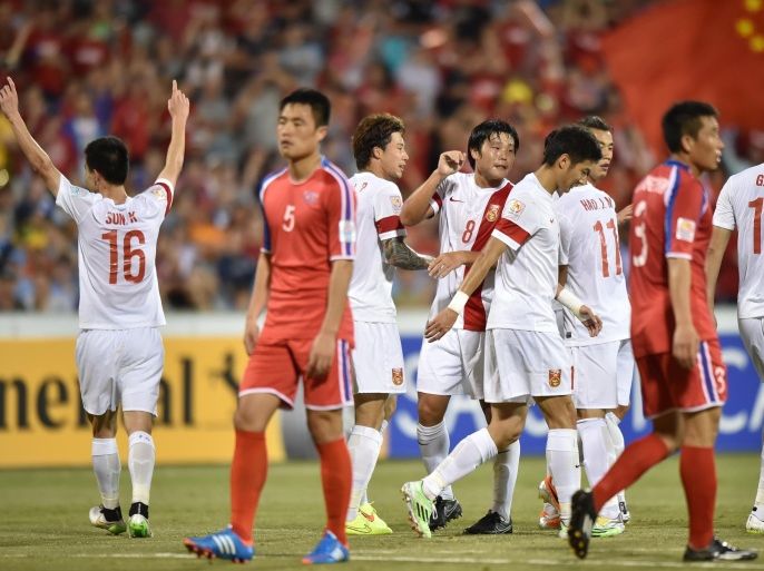 China (in white) celebrate scoring their second goal against North Korea during their Group B football match of the AFC Asian Cup in Canberra on January 18, 2015. AFP PHOTO/Peter PARKS --IMAGE RESTRICTED TO EDITORIAL USE - STRICTLY NO COMMERCIAL USE