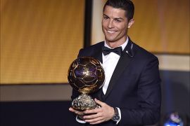 Real Madrid and Portugal forward Cristiano Ronaldo smiles after receiving the 2014 FIFA Ballon d'Or award for player of the year during the FIFA Ballon d'Or award ceremony at the Kongresshaus in Zurich on January 12, 2015. AFP PHOTO / FABRICE COFFRINI
