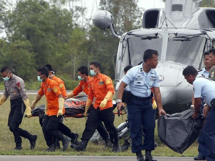 Indonesian rescuers unload bodies from an Indonesian navy helicopter during a search and rescue operation at Iskandar Military Airport in Pangkalan Bun, Central Borneo, Indonesia, 03 January 2015. Indonesian ships have detected two large objects believed to be parts of the AirAsia plane that crashed off Borneo island with 162 people on board, the search chief said on 03 January. AirAsia's Airbus A320-200 crashed on 28 December halfway through a two-hour flight between Surabaya, Indonesia's second-largest city, and Singapore. At least 30 bodies have been retrieved from the crash site.