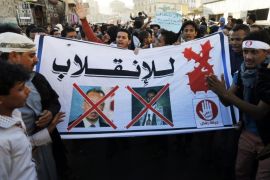 Protesters hold a banner showing crossed-out pictures of United Nations (U.N.) special envoy to Yemen Jamal Benomar (L) and the leader of Yemen's Houthis Abdel-Malek al-Houthi, during a demonstration against the Houthi movement in Sanaa January 28, 2015. Houthi, leader of the Houthis who control the capital Sanaa, said on Tuesday his group was seeking a peaceful transfer of power after the resignation of Yemeni President Abd-Rabbu Mansour Hadi, and urged all factions to work together to solve the crisis. The banner reads: "No to the coup!" REUTERS/Khaled Abdullah (YEMEN - Tags: POLITICS CIVIL UNREST)