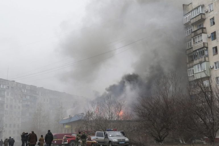 Smoke and flames rise above a burning building after shelling in the eastern Ukrainian city of Mariupol, 24 January 2015. Fifteen civilian people were killed and 46 injured during a shelling at Jan.24 morning in Mariupol according to a UNIAN agency report.