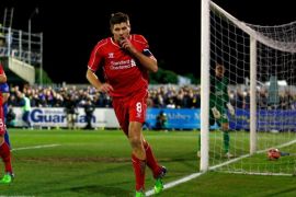 KINGSTON UPON THAMES, ENGLAND - JANUARY 05: Steven Gerrard of Liverpool celebrates after scoring the opening goal with a header during the FA Cup Third Round match between AFC Wimbledon and Liverpool at The Cherry Red Records Stadium on January 5, 2015 in Kingston upon Thames, England.