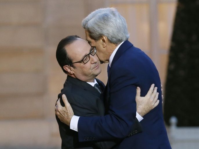 French president François Hollande (L) welcomes US Secretary of State John Kerry prior to a meeting at the Elysee Palace on January 16, 2015 in Paris. Kerry's visit came after criticism of the US for not sending a top-level representative to a march in Paris on January 11, which drew 1.5 million people and dozens of world leaders in the wake of the attacks. AFP PHOTO PATRICK KOVARIK