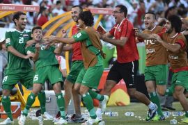 Dhurgham Ismael of Iraq (2nd L) celebrates scoring a penalty goal in extra time against Iran during their AFC Asian Cup quarter-final football match in Canberra on January 23, 2015. AFP PHOTO/Peter PARKS --IMAGE RESTRICTED TO EDITORIAL USE - STRICTLY NO COMMERCIAL USE