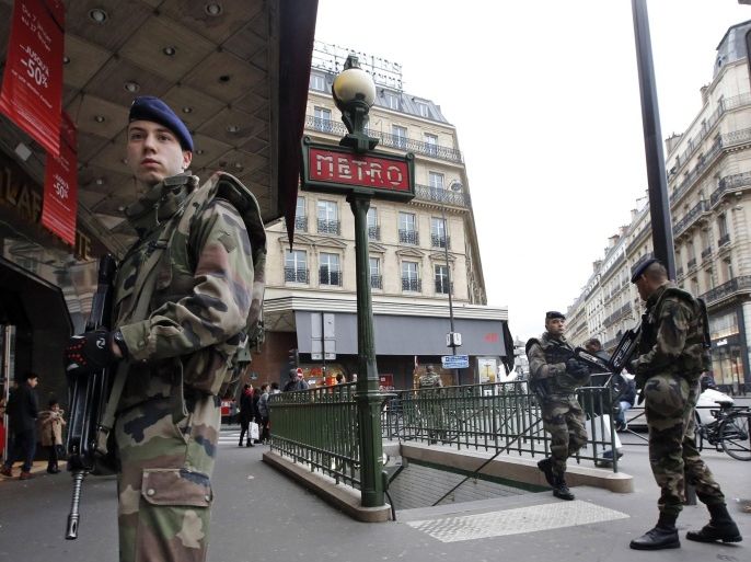 French soldiers patrol in the street near a department store in Paris as part of the highest level of "Vigipirate" security plan in Paris January 10, 2015. French police searched for a female accomplice to militant Islamists behind deadly attacks on the satirical Charlie Hebdo weekly newspaper and a kosher supermarket and maintained a top-level anti-terrorist alert ahead of a Paris gathering with European leaders and demonstration set for Sunday. In the worst assault on France's homeland security for decades, 17 victims lost their lives in three days of violence that began with an attack on the Charlie Hebdo weekly on Wednesday and ended with Friday's dual hostage-taking at a print works outside Paris and kosher supermarket in the city. REUTERS/Eric Gaillard (FRANCE - Tags: CRIME LAW MILITARY)