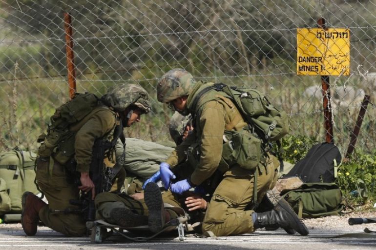 Wounded Israeli soldiers receive medical treatment after their army vehicle was hit by anti-tank missile, near the Har Dov area, on the Israeli-Lebanese border, 28 January 2015. An Israeli military vehicle was hit by an anti-tank missile near the border with Lebanon, the army said. Israeli emergency services said there were injuries in the incident. Israel responded by firing several rockets toward south-eastern Lebanon, according to a Lebanese security source. Israeli troops had been operating in the area, local media said, searching for possible tunnels dug by the Hezbollah militant group. Israel has been anticipating an attack from Hezbollah after it killed six fighters of the Iran-backed Shiite militant group in an air strike in Syria earlier this month.