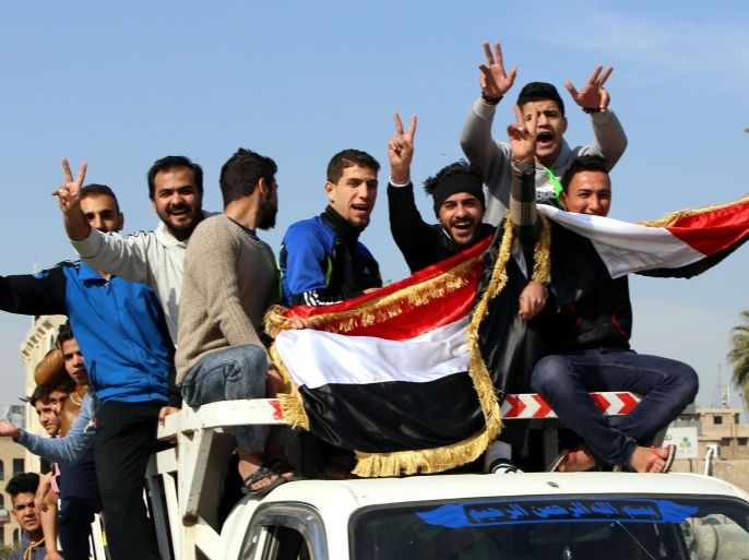 Iraqis take down to the streets of Baghdad on January 23, 2015 to celebrate the winning of the Iraqi National Football team over Iran during the 2015 Asian cup taking place in Australia. Salam Shakir scored the winning spot-kick as Iraq stunned 10-man Iran 7-6 on penalties to reach the Asian Cup semis in a match of high drama between the arch-rivals on Friday. AFP PHOTO / ALI AL-SAADI