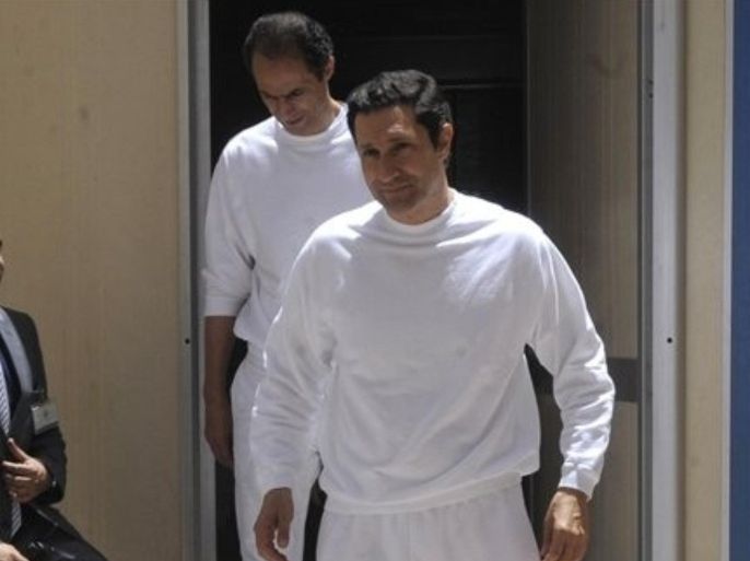 The two sons of ex-President Hosni Mubarak, Gamal, left, and Alaa Mubarak, right, arrive to the police academy courthouse in Cairo, Egypt, Saturday, June 2, 2012. The two brothers were acquitted of corruption charges, but still face separate trial on charges of insider trading. Hosni Mubarak was sentenced to life in prison Saturday for his role in the killing of protesters during last year's revolution that forced him from power, a verdict that caps a stunning fall from grace for a man who ruled the country as his personal fiefdom for nearly three decades.