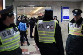 Security personnel (front) and policemen stand next to an entrance to a hospital where injured people of a stampede incident are treated, in Shanghai, January 1, 2015. At least 35 people were killed and 42 were injured in a stampede during a New Year's celebration on the Bund, a waterfront area in central Shanghai, official Chinese government television CCTV America reported on its website. REUTERS/Aly Song (CHINA - Tags: DISASTER HEALTH SOCIETY)