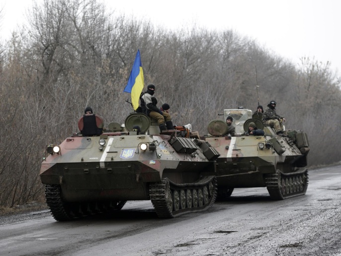 A Ukranian armored vehicle is towed on the road towards the town of Artemivsk, Ukraine, Friday, Jan. 30, 2015. Fighting between government and Russian-backed separatist forces in eastern Ukraine has intensified in recent days as rebels seek to encircle the town of Debaltseve, which hosts a strategically important railway hub. (AP Photo/Petr David Josek)