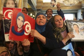 Loved ones of protesters, who died in protests during Tunisia's 2011 revolution, hold pictures and shout slogans during celebrations marking the fourth year anniversary of the revolution, at the Carthage Palace in Tunis January 14, 2015. REUTERS/Zoubeir Souissi (TUNISIA - Tags: POLITICS ANNIVERSARY CIVIL UNREST)