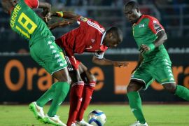 Burkina Faso's midfielder Charles Kabore (L) and Burkina Faso's midfielder Djakaridja Kone (R) challenge Congo's midfielder Prince Oniangue during the 2015 African Cup of Nations group A football match between Congo and Burkina Faso in Ebebiyin on January 25, 2015. AFP PHOTO / KHALED DESOUKI