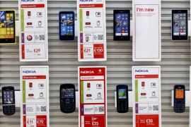 Nokia Lumia Windows smartphones and Asha mobile phones, manufactured by Nokia Oyj, sit on a wall display inside a Vodafone Group Plc store in Manchester, U.K., on Tuesday, Sept. 3, 2013. Microsoft Corp. agreed to buy Nokia Oyj's handset business and license its patents for 5.44 billion euros ($7.2 billion), casting together the lot of two companies trying to stay relevant against fleet-footed technology rivals.