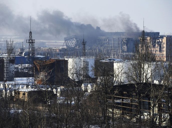 In this Thursday, Jan. 15, 2015 photo, smoke rises over the new terminal of Donetsk airport in Donetsk, Eastern Ukraine. Russian-backed separatists announced Thursday they had captured the shattered remains of the Donetsk airport terminal and plan to claw back more territory, further dashing hopes for a lasting peace agreement. (AP Photo/Mstyslav Chernov)