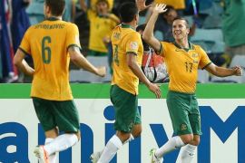 SYDNEY, AUSTRALIA - JANUARY 13: Matt McKay of the Socceroos is congratulated by team mates after scoring a goal during the 2015 Asian Cup match between Oman and Australia at ANZ Stadium on January 13, 2015 in Sydney, Australia.