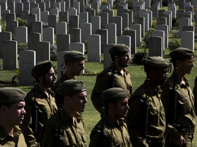 Israeli military honor guards attend a Remembrance Day ceremony to honor war veterans who fought in the British Armed Forces during the World Wars and to commemorate 100 years since start of World War I, at the Commonwealth War Graves Commission in the central Israeli town of Ramla, Sunday, Nov. 9, 2014. (AP Photo/Oded Balilty)