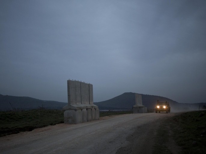 An Israeli military vehicle drives in the Israeli-controlled Golan Heights, on the border with Syria, Tuesday, Jan. 27, 2015. At least two rockets launched from Syria struck the Israeli-controlled Golan Heights on Tuesday and Israel responded with artillery fire, the Israeli military said. The fire comes after an airstrike last week in Syria attributed to Israel that killed six members of the Lebanese militant group Hezbollah and an Iranian general. Iran's official IRNA news agency is reporting the country has sent a warning to Israel through the United States over the recent killing of the Iranian general. (AP Photo/Ariel Schalit)