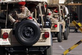 Soldiers in a convoy secure a military funeral ceremony of security personnel killed in attacks in Sinai, outside Almaza military airbase where the funerals were held, in Cairo, January 30, 2015. Islamic State's Egyptian wing has claimed the killing of at least 30 soldiers and police officers in the Sinai Peninsula. The four separate attacks on security forces in North Sinai on Thursday night were among the bloodiest in years and the first significant assault in the region since the most active Sinai militant group swore allegiance to IS in November. REUTERS/Asmaa Waguih (EGYPT - Tags: POLITICS CIVIL UNREST MILITARY OBITUARY)